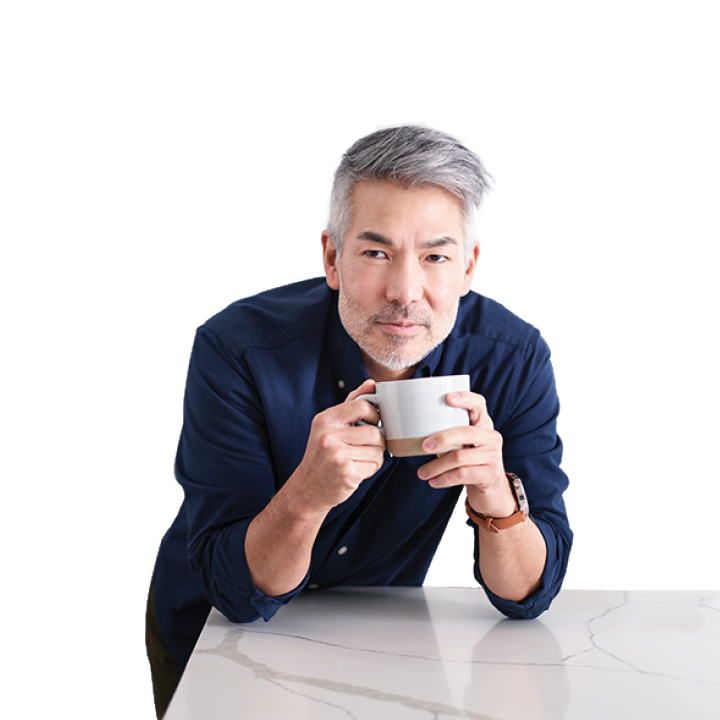 man in kitchen with cup of espresso